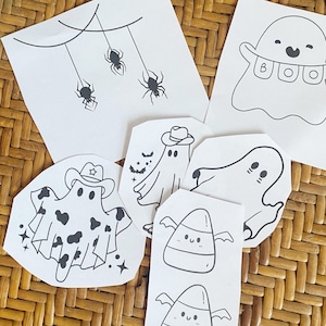May include: A set of printable Halloween-themed colouring pages featuring ghosts, candy corn, and spiders. The ghosts are dressed in various costumes, including a cowboy hat and a cow print.