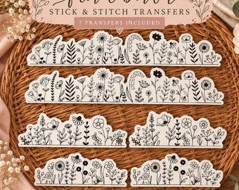 May include: Seven stick and stitch embroidery transfers featuring black line art of various wildflowers and foliage arranged in borders. The text reads floral border STICK & STITCH TRANSFERS 7 TRANSFERS INCLUDED. The designs are on white paper.