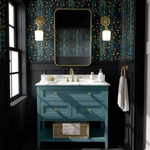 May include: A teal blue bathroom vanity with gold hardware and a white marble countertop. The vanity has three drawers and a lower shelf. The bathroom is decorated with black walls and gold accents.