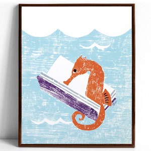 An art print of an orange seahorse reading the purple covered book he’s holding with his tail while floating in light blue water