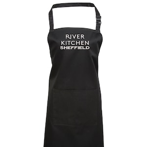 May include: Black apron with a large white pocket and the text "River Kitchen Sheffield" embroidered on the front.