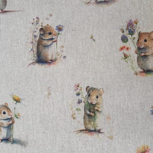 May include: A beige fabric with a repeating pattern of brown mice holding flowers. The mice are depicted in a whimsical style with delicate features and are surrounded by small, colourful flowers.
