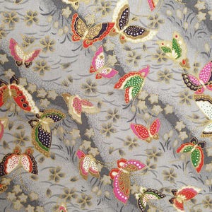May include: A fabric pattern featuring colorful butterflies in shades of red, pink, green, and gold against a gray background. The butterflies are interspersed with small, star-shaped floral elements, creating a whimsical design.