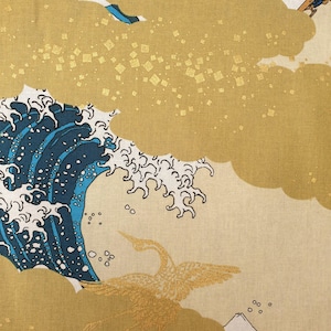 May include: Fabric with a Japanese-inspired design featuring a large ocean wave in shades of blue and white, gold clouds, and a crane. The background is a light beige color, with a mountain and boat in the distance.