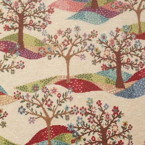May include: A beige fabric with a repeating pattern of stylised trees with pink, blue, and red flowers. The trees are brown and the background is a mix of green, blue, red, and pink.