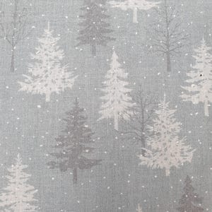 May include: A fabric with a winter forest pattern. The design features white and grey fir trees and bare trees on a light blue background. Small white dots represent falling snow, creating a seasonal, festive feel.