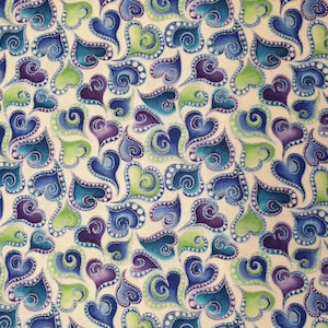 May include: A fabric pattern featuring stylized hearts in shades of blue, teal, green, and purple, with white dot accents and swirling details. The hearts are arranged on a cream-colored background.