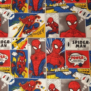 May include: Comic book fabric featuring Spider-Man in various action poses. The design includes speech bubbles with phrases like "Pow" and "With great power comes great responsibility." The color palette is dominated by red, blue, and yellow.
