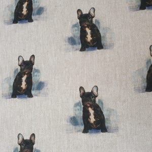 May include: A white fabric with a repeating pattern of black French Bulldogs. The dogs are in various poses, some sitting, some standing, and some looking at the camera.