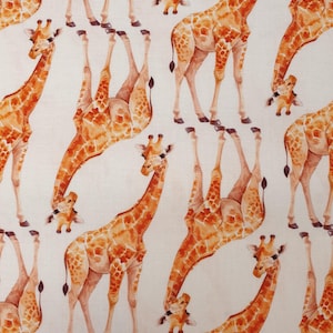 May include: A repeating pattern of giraffes in shades of orange and brown against a cream background. The giraffes are depicted in various poses, some upright and others upside down, creating a playful and whimsical design. The pattern is suitable for fabric or wallpaper.