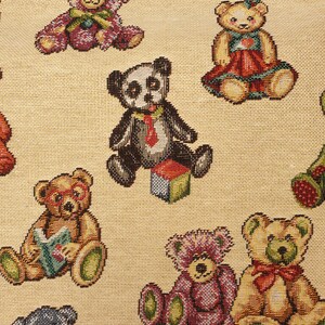 May include: A beige fabric featuring a repeating woven pattern of various teddy bears. The bears are depicted in multiple colors including purple, brown, and black, with some wearing red bows or ties, reading books, or sitting next to colorful blocks.