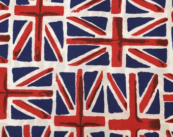May include: A white fabric with a repeating pattern of red, white, and blue Union Jack flags. The flags are stylized and have a hand-painted look.