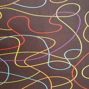 May include: Close-up of a fabric with a dark brown background. The fabric features a pattern of colourful, swirling lines in red, yellow, blue, and purple. The lines create a dynamic, abstract design.