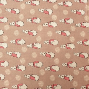 May include: A pink fabric with a repeating pattern of white rabbits wearing red jackets. The rabbits are facing left and right, and the background is a light pink with small white dots.