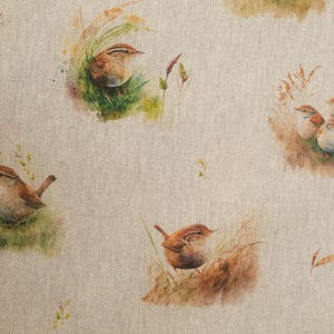May include: A beige fabric with a repeating pattern of brown birds in a natural setting. The birds are depicted in a watercolor style with brown, white, and gray tones.