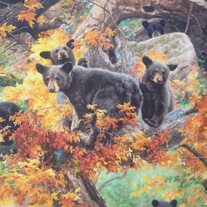 May include: A fabric print featuring multiple black bear cubs nestled within a large tree. The scene is filled with vibrant autumn foliage in shades of orange, yellow, and red, set against a backdrop of textured tree bark and branches.