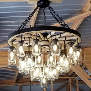 A Wagon Wheel Chandelier with a mix of rustic/vintage features and finishing techniques creating a unique handcrafted chandelier