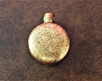 Gold tone, metal covered pendent perfume bottle