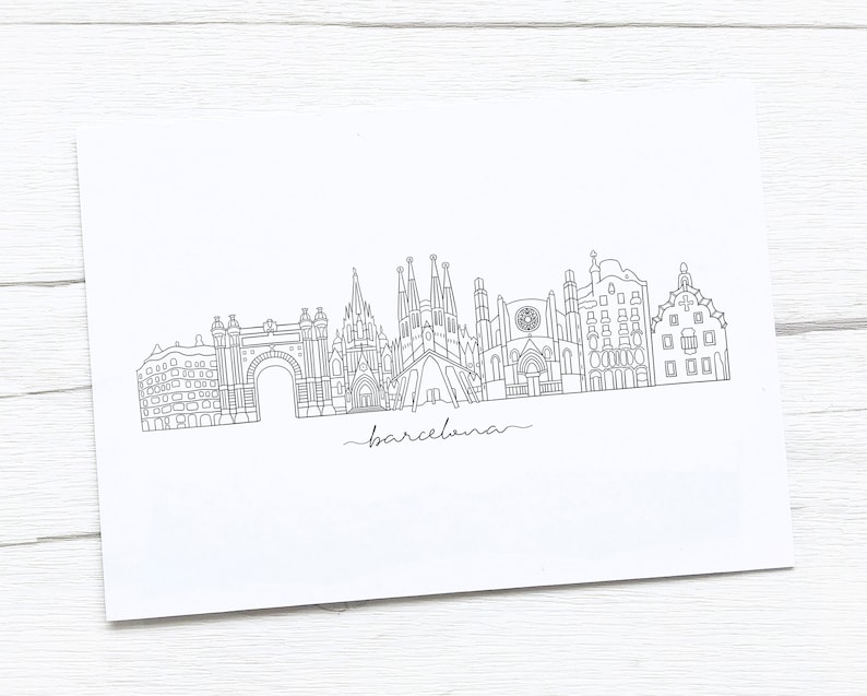 May include: A black and white line drawing of the Barcelona skyline, featuring iconic landmarks like the Sagrada Familia and Arc de Triomf. The word "barcelona" is written in cursive below the skyline.