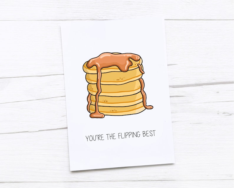 Op de afbeelding: Een kaart met een cartoonillustratie van een stapel pannenkoeken met siroop. De tekst op de kaart luidt "You're the flipping best."