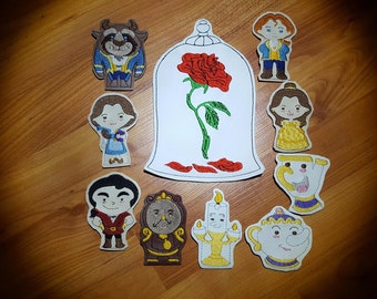 May include: A set of ten embroidered felt finger puppets featuring characters from the Disney movie Beauty and the Beast. The characters include Belle, Beast, Gaston, Mrs. Potts, Lumiere, Cogsworth, Chip, and the enchanted rose.
