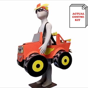 May include: A red and yellow cardboard monster truck costume for kids. The costume includes a truck body with wheels and a headpiece with a yellow flame design. The costume is designed to be worn by a child and has a strap to hold it in place. The text "ACTUAL COSTUME KIT" is visible in the image.