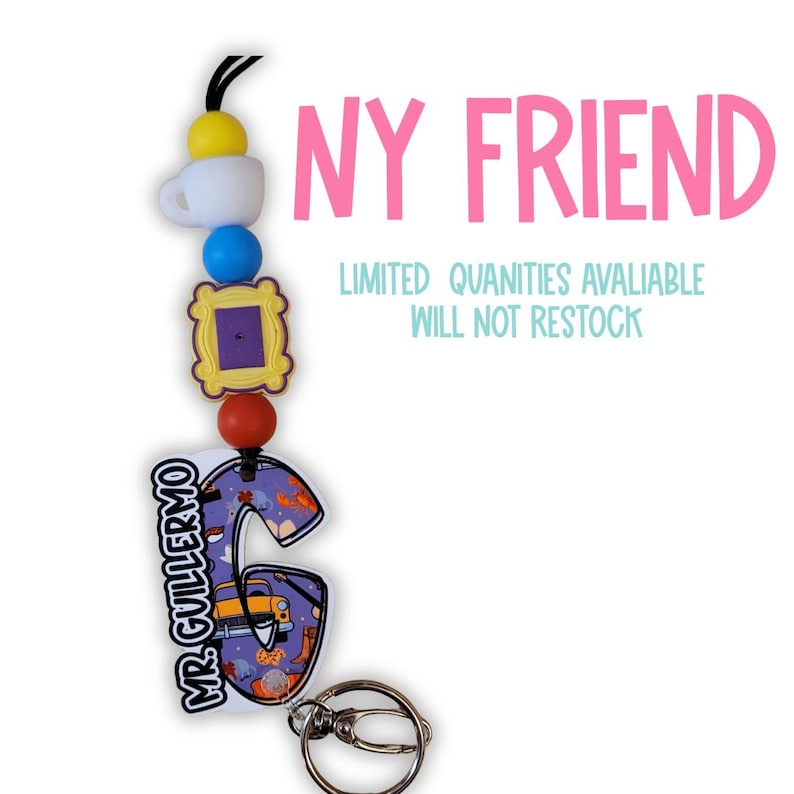 May include: A lanyard with a series of charms, including a white coffee cup, a blue bead, a yellow picture frame, and a red bead. The lanyard also features a purple letter "G" with a cartoon design and the text "MR. GUILLERMO". The text "NY FRIEND" is in pink.