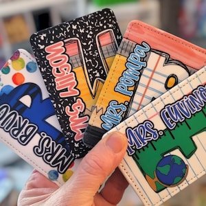 May include: A collection of colorful, personalized teacher gifts. Each item features a unique design, including a pencil, notebook paper, and a globe. The names "Mrs. Wilson", "Mrs. Pompa", "Mrs. Fuvino", and "Mrs. Drug" are displayed.