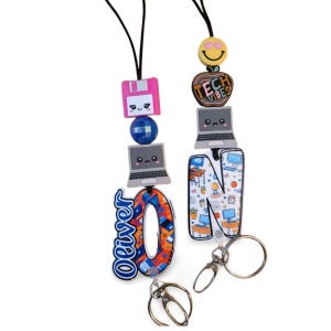 May include: Two lanyards with tech-themed charms. One features the name "Oliver" and a letter "O" charm. The other has a letter "N" charm with a desk scene. Both have computer, floppy disk, and smiley face charms.