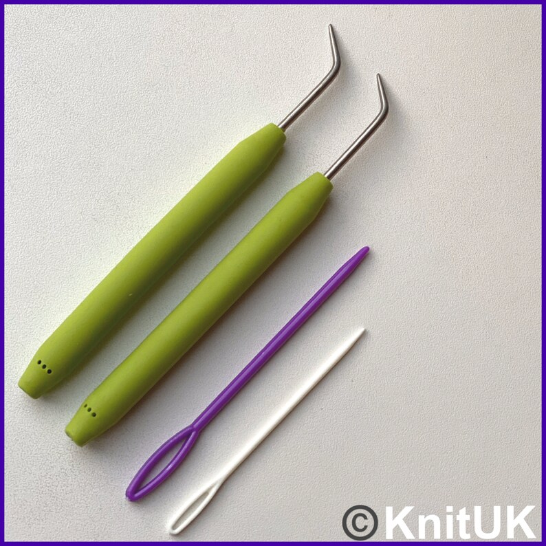 May include: Two green crochet hooks with metal tips and a purple and white yarn needle.