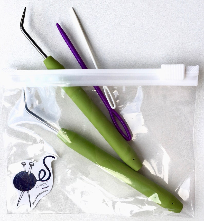 May include: A clear plastic zippered bag containing two green crochet hooks and two yarn needles, one purple and one white. The bag has a small sticker with the text "KnitUK KnitUK shop at KnitUK.com".