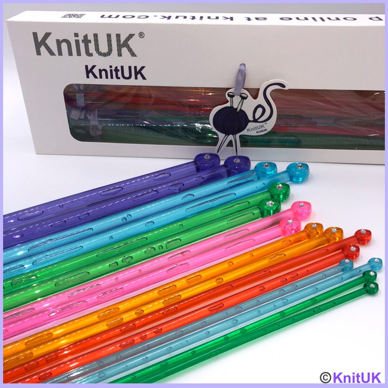 May include: A set of 15 colorful plastic knitting needles with clear tips and colorful caps. The needles are arranged in a rainbow pattern, with the purple needles at the top and the green needles at the bottom. The needles are all the same size, and they are packaged in a white box with the KnitUK logo.