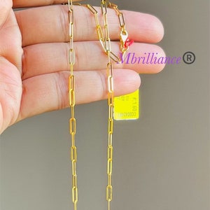 Puede incluir: Un collar de cadena de oro con una etiqueta de papel que dice "#5160 50 2CY". La etiqueta tambi&eacute;n tiene el texto "Mbrilliance" y un s&iacute;mbolo de marca registrada.