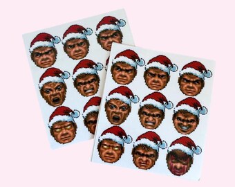 May include: A sheet of stickers featuring 12 different pixelated faces of a character wearing a Santa hat. The character has a variety of facial expressions, including angry, surprised, and happy.