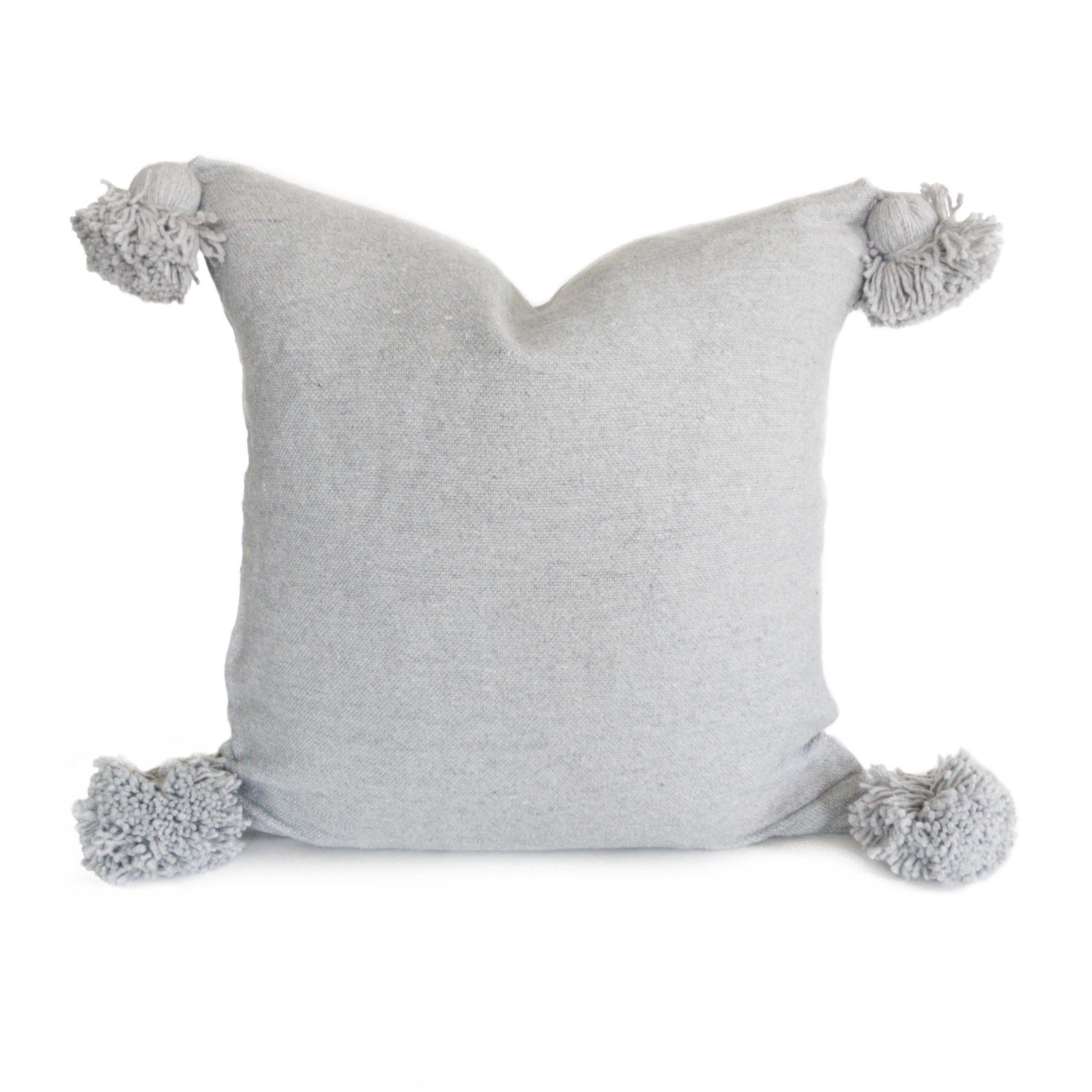gray pom pom pillow