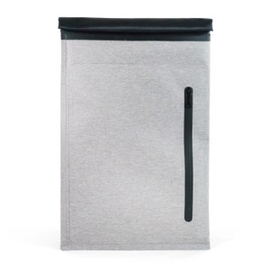 May include: A gray laptop sleeve with a black zipper and a black flap. The sleeve is made of a water-resistant material.