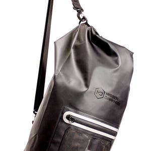May include: Black waterproof duffel bag with a clear windowed pocket and an adjustable shoulder strap. The bag has the text "Mission Darkness" printed on the front.