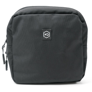 May include: Black rectangular pouch with a textured surface and a zipper closure. A small white and black logo is centered on the front. The pouch is designed to hold small items and has a compact shape.