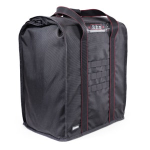 May include: Black duffel bag with red stitching and a large zippered pocket on the front. The bag has two large handles and a small patch with the text "Tactical Duffel Bag" on the front.