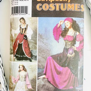 May include: Simplicity Costumes pattern featuring medieval-style dresses. The pattern includes sizes HH 6, 8, 10, and 12. The cover displays images of the finished costumes in shades of red, pink, black, and white.