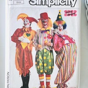 May include: A Simplicity sewing pattern envelope for clown costumes in size Large. The front features three clowns in colorful outfits: one in a red and yellow jester suit, one in a plaid vest with green polka-dot pants, and one in a pink and striped jumpsuit.