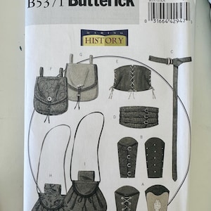 May include: Butterick sewing pattern B5371 for accessories including pouches, belts, and arm guards. The white envelope features black line drawings of various historical-style items labeled A through I, with a barcode and size XN at the top.