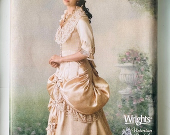 May include: A Simplicity sewing pattern envelope, number 244, featuring a photograph of a person wearing a champagne-colored gown with lace trim, a high collar, and a bustle. The text includes size RR 14, 16, 18, 20 and Wrights Victorian Bridal Museum.