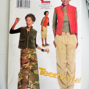 May include: A Butterick sewing pattern featuring a young person modeling various outfits. The outfits include a red vest, khaki pants, a green long-sleeve shirt, a green vest, and a camouflage skirt. The pattern is for sizes 9/10 to 13/14. The text "Teen Style!" is visible.
