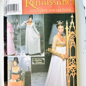 May include: A Simplicity Renaissance Costume Collection sewing pattern envelope featuring illustrations of three different long dresses with empire waists and long sleeves. The package includes sizes 6, 8, 10, and 12, with the designer name Andrea Schewe.