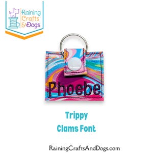 May include: A square keychain featuring a vibrant, multi-colored marbled pattern in shades of pink, blue, and orange. The name Phoebe is embroidered in dark purple thread across the front. A white snap button and a silver metal ring are attached.