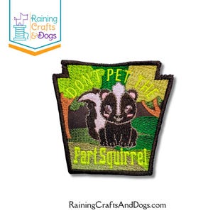 May include: Embroidered patch featuring a cartoon skunk with the text "DON'T PET THE FART SQUIRREL." The patch has a green and yellow background with trees. The skunk is black and white with a cute expression.