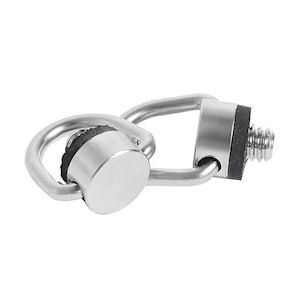 May include: Two silver metal D-ring camera strap mounts with black rubber inserts. The mounts have a threaded screw on one side.