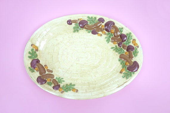 A genuine vintage 1970s large ceramic mushroom platter — handmade, boho-retro, and dripping with the kind of kitschy fungal charm that's absolutely having a cultural moment.