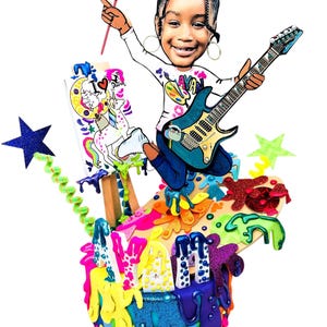 May include: A vibrant illustration of a girl playing a blue electric guitar and holding a paintbrush. She stands on a colourful artist's palette with dripping paint. A canvas displays a unicorn and the words "I Love Dance".